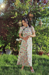 a lady in a floral print qipao dress